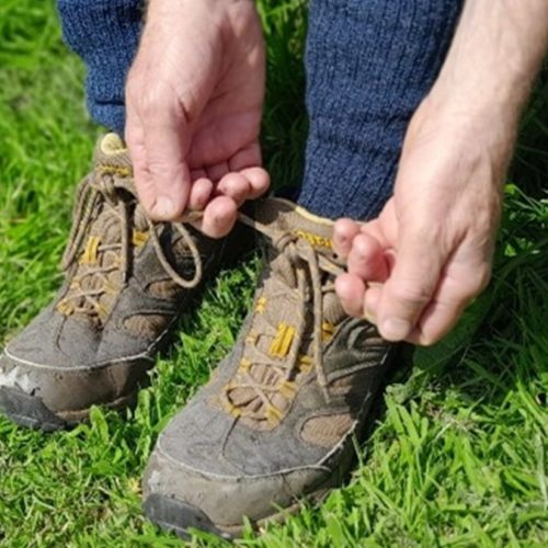 A photograph of somebody tying their shoelaces